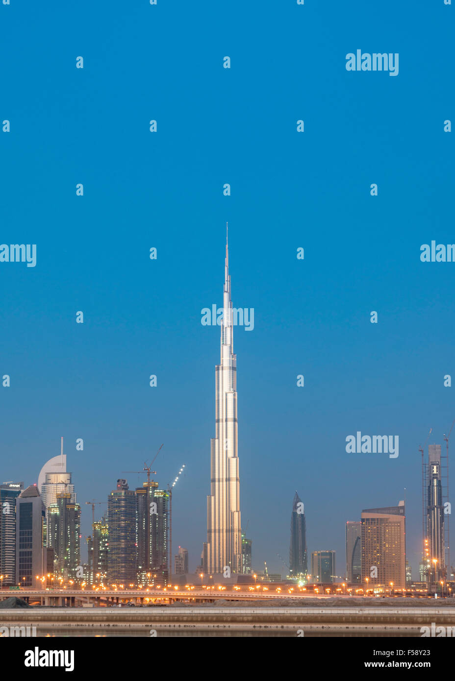 Skyline of skyscrapers and Burj Khalifa tower before sunrise in Dubai United Arab Emirates Stock Photo