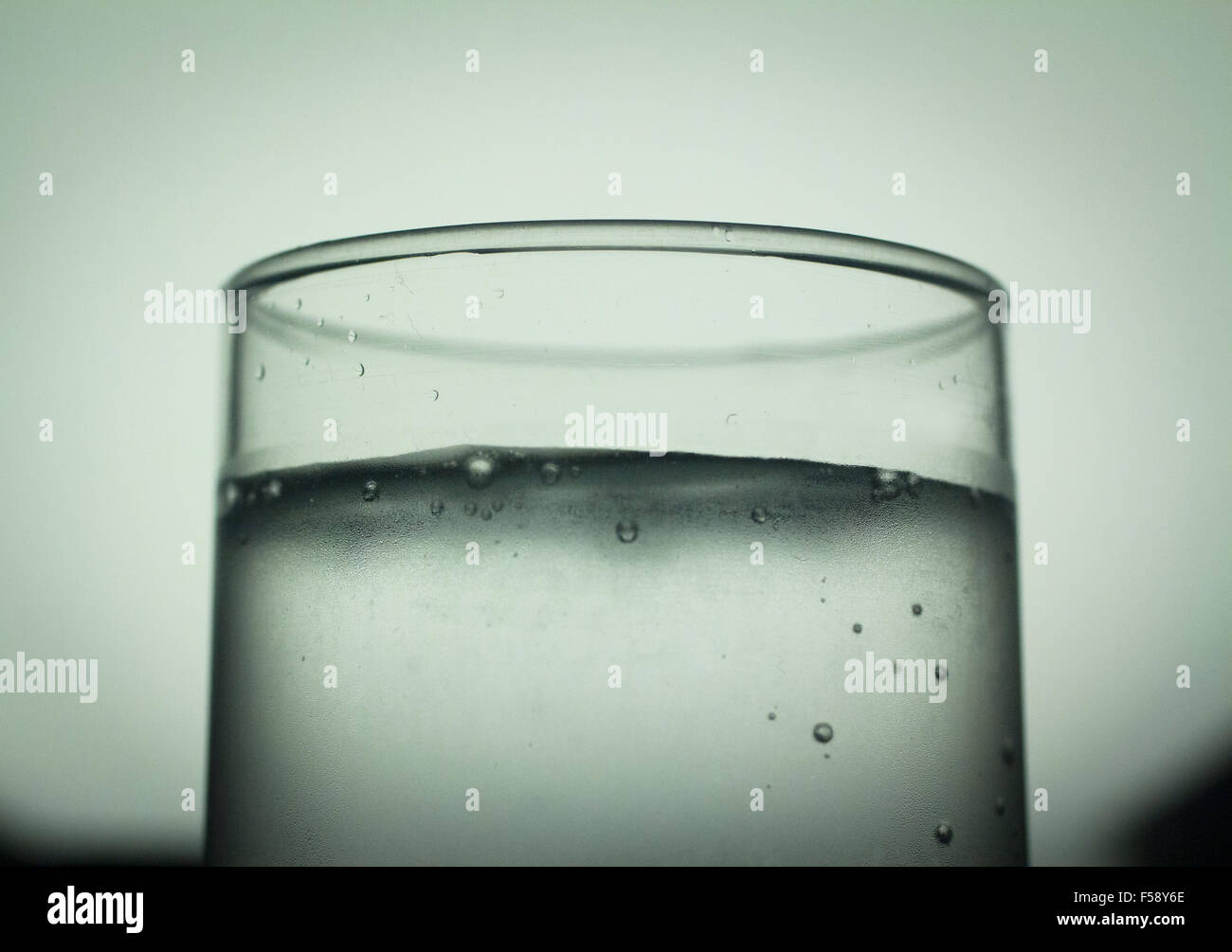 Glass of sparkling water soft drink closeup on carbon dioxide gas