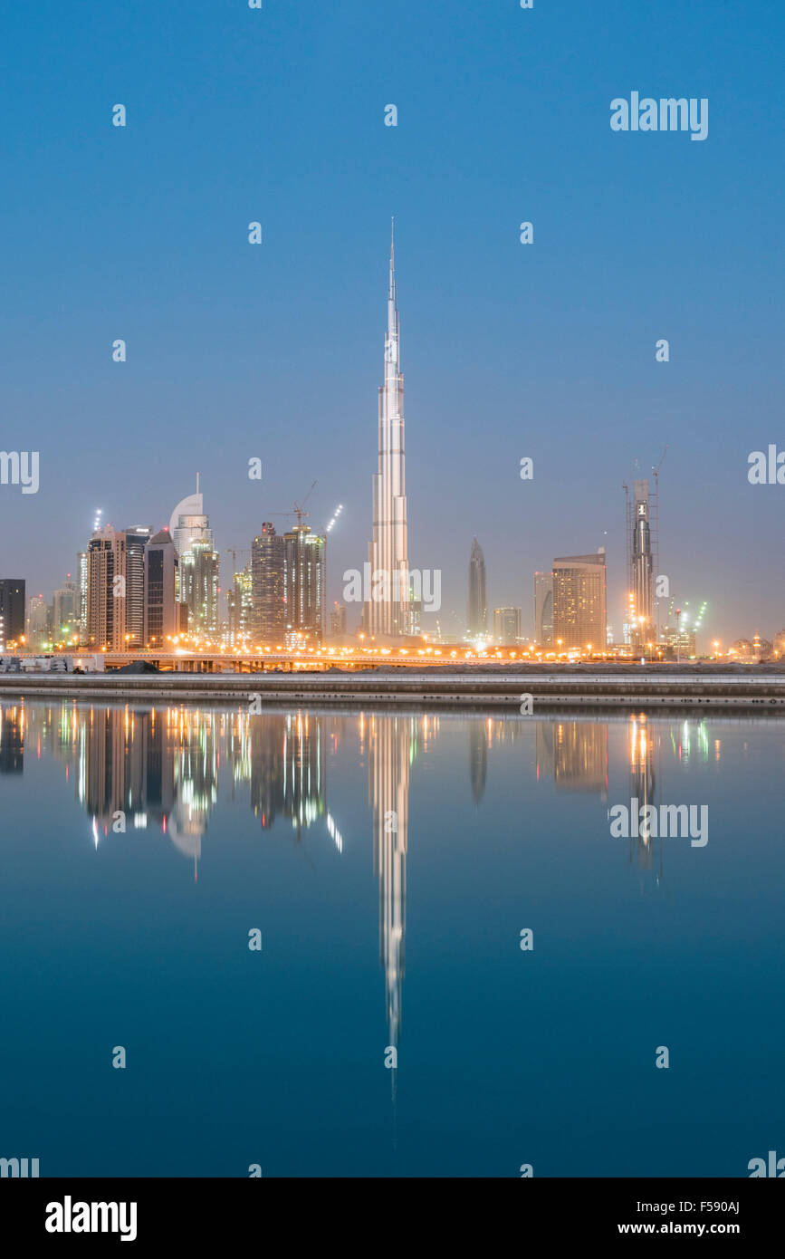 Skyline of skyscrapers and Burj Khalifa tower before sunrise in Dubai United Arab Emirates Stock Photo
