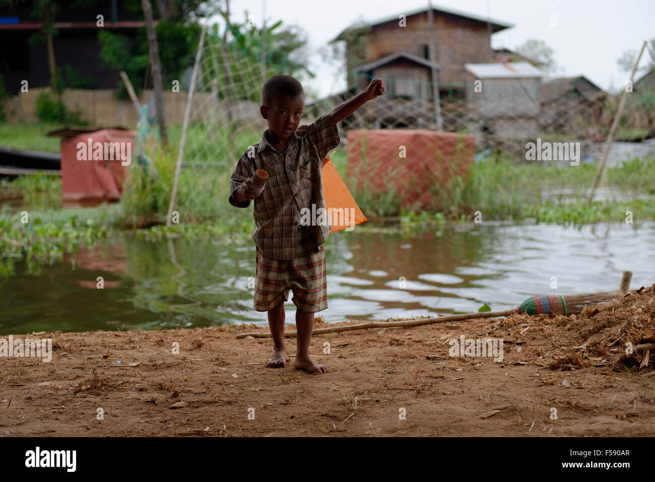 Inle Lake, youngl boy playing with a kite Stock Photo