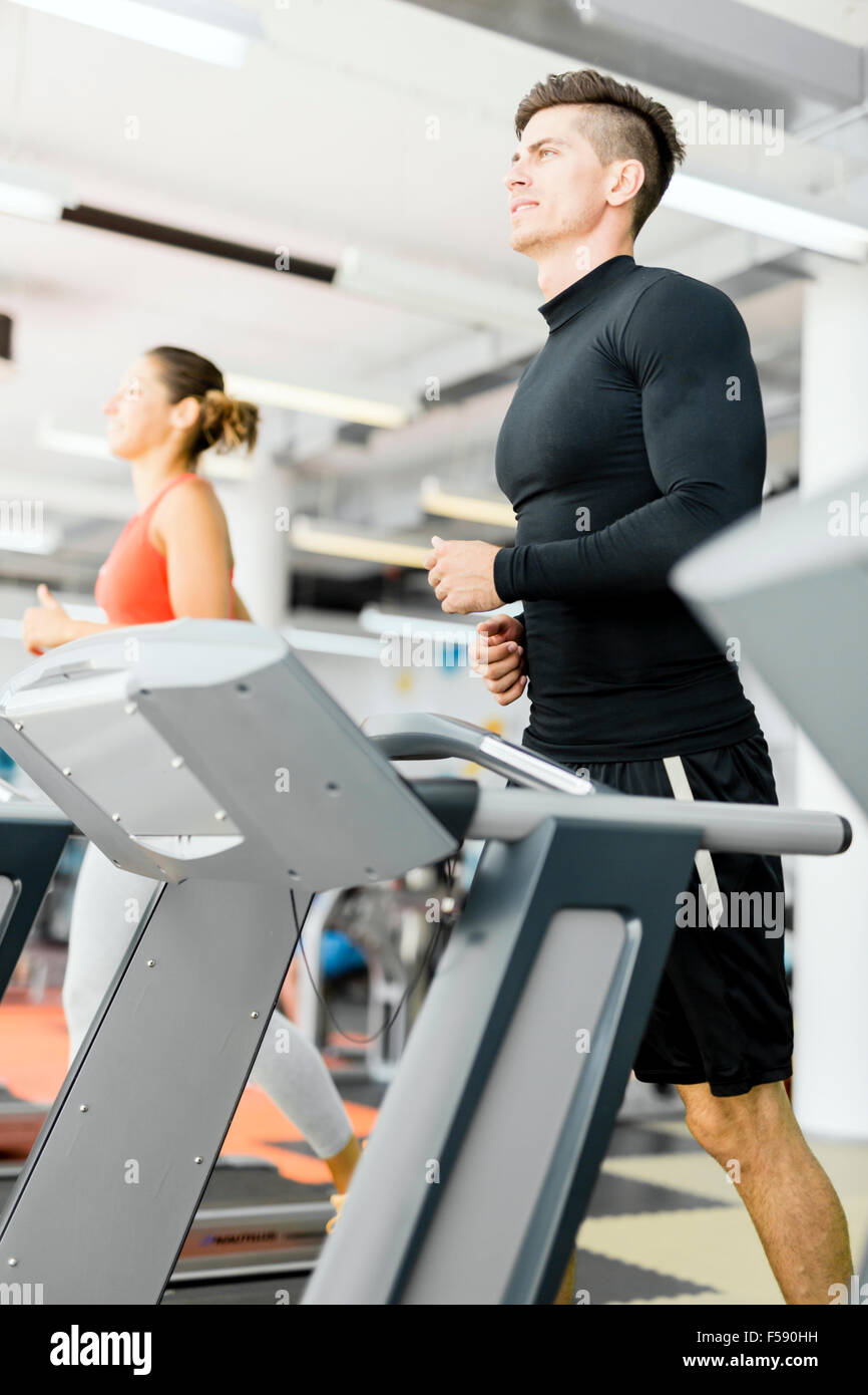 Group of young people running on treadmills in a fitness center Stock Photo