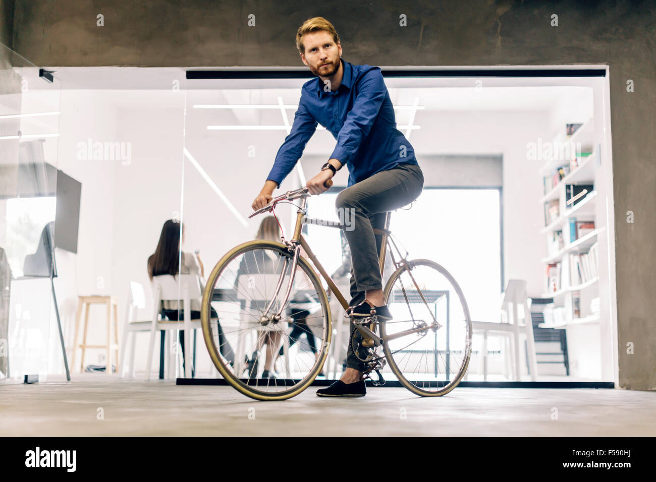 Businessman riding a bicycle to work Stock Photo Alamy