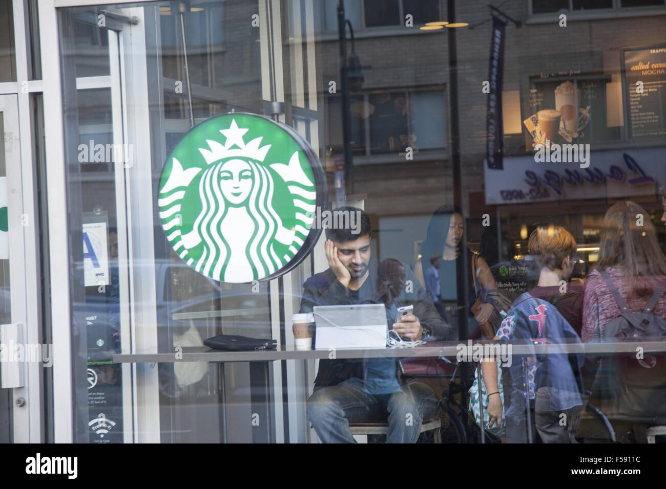 Starbucks window on 14th Street in New York City. Stock Photo