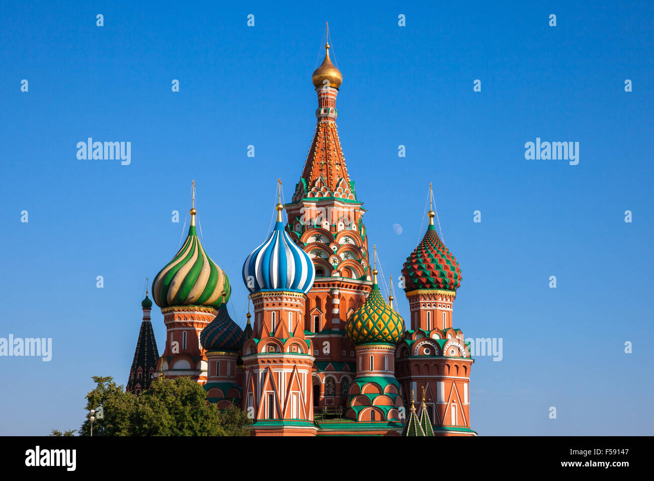 Close-up view of the famous Saint Basil's Cathedral with moon rising between its domes, Red Square, Moscow, Russia. Stock Photo