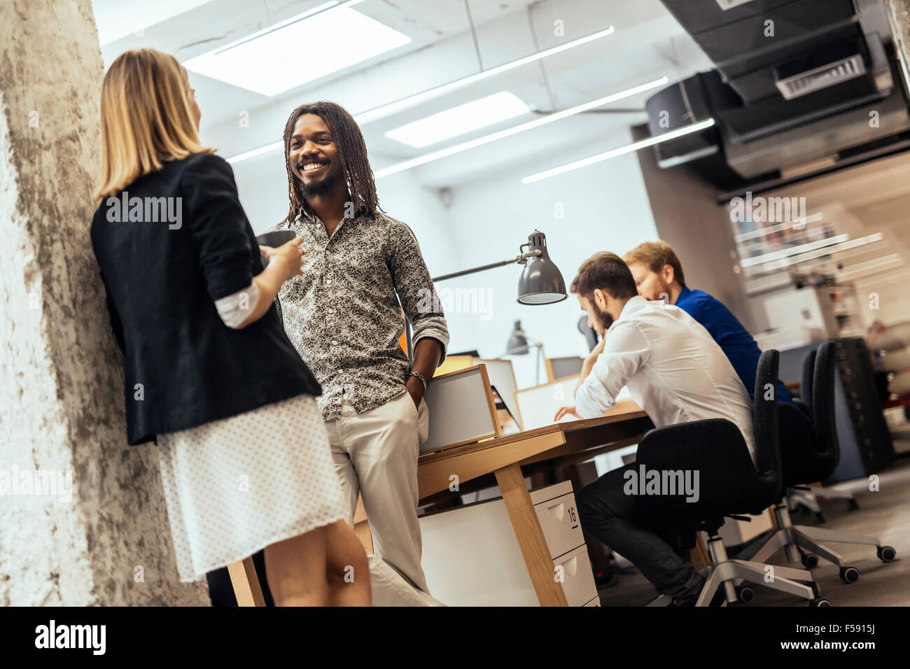 Business colleagues talking in the office Stock Photo - Alamy
