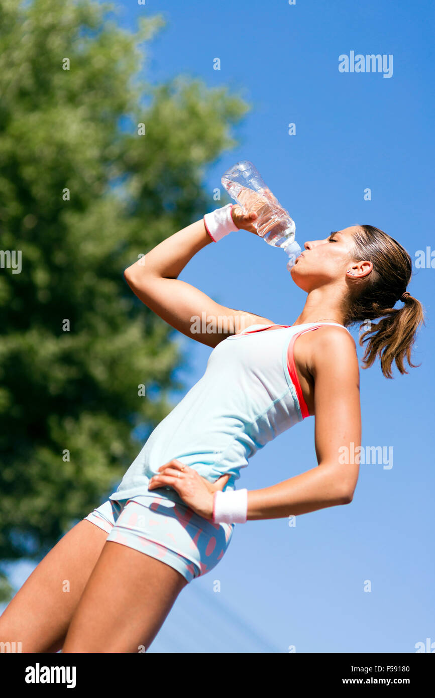 Young beautiful athlete drinking water after exercising to revitalize Stock  Photo - Alamy, image size:866x1390