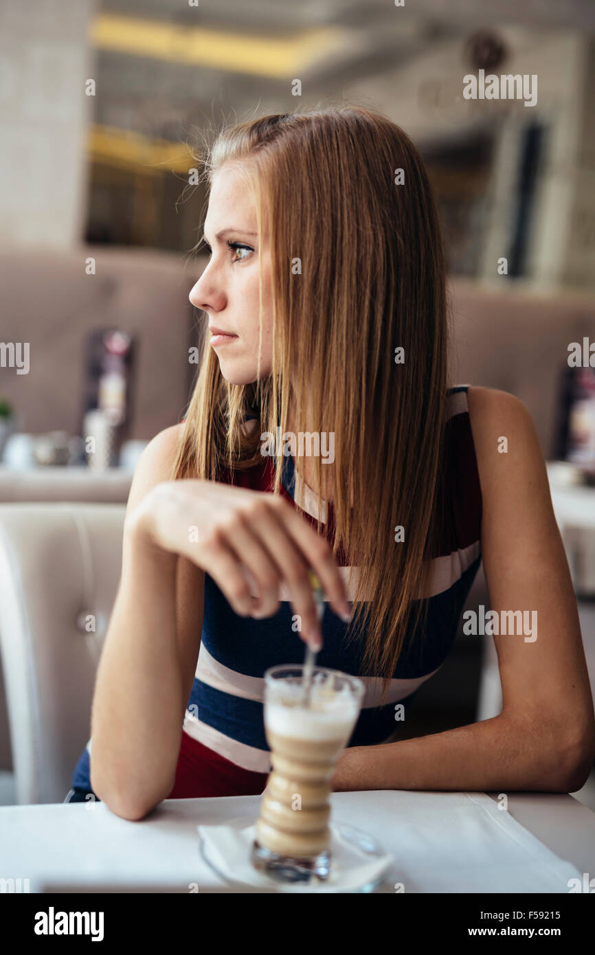 Beautiful woman in cafe drinking coffee Stock Photo