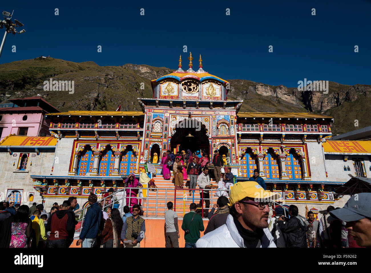 Badrinath temple with heavy devotee crowd and beautiful nature sky. Colorful Badrinath temple architecture Stock Photo
