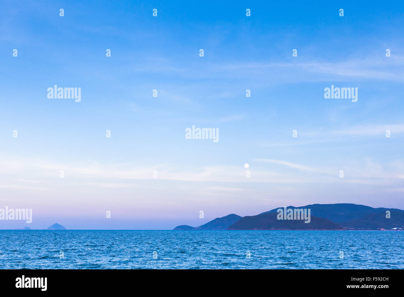 Full moon rises over Nha Trang beach, Vietnam. Stock Photo