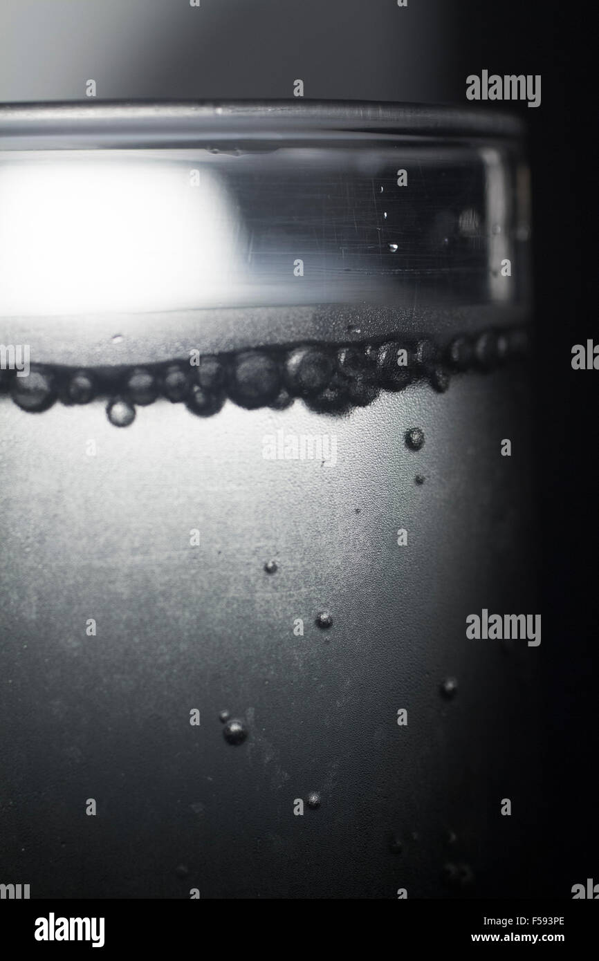 Glass of sparkling water soft drink closeup on carbon dioxide gas