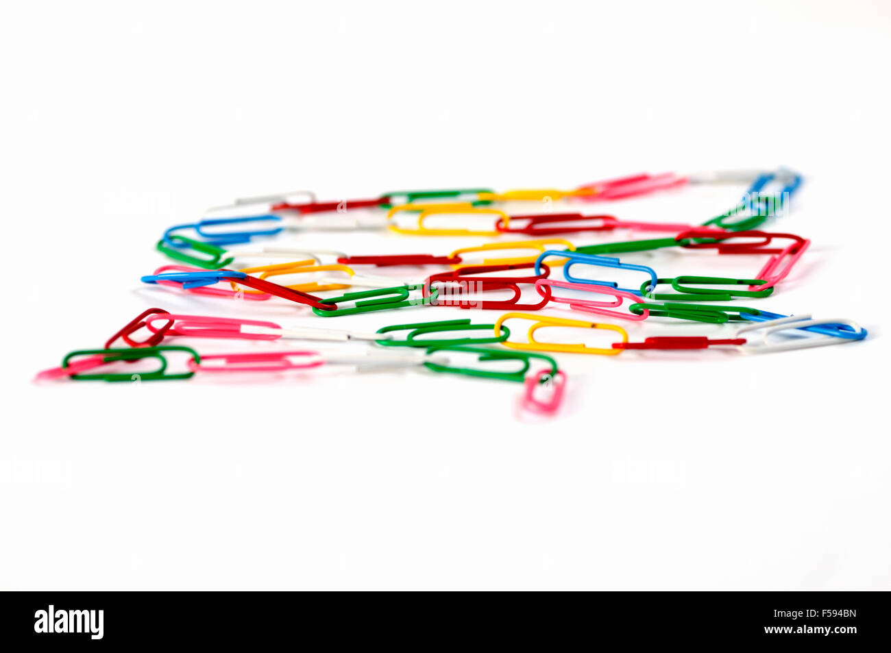 Coloured paper clips on white background Stock Photo