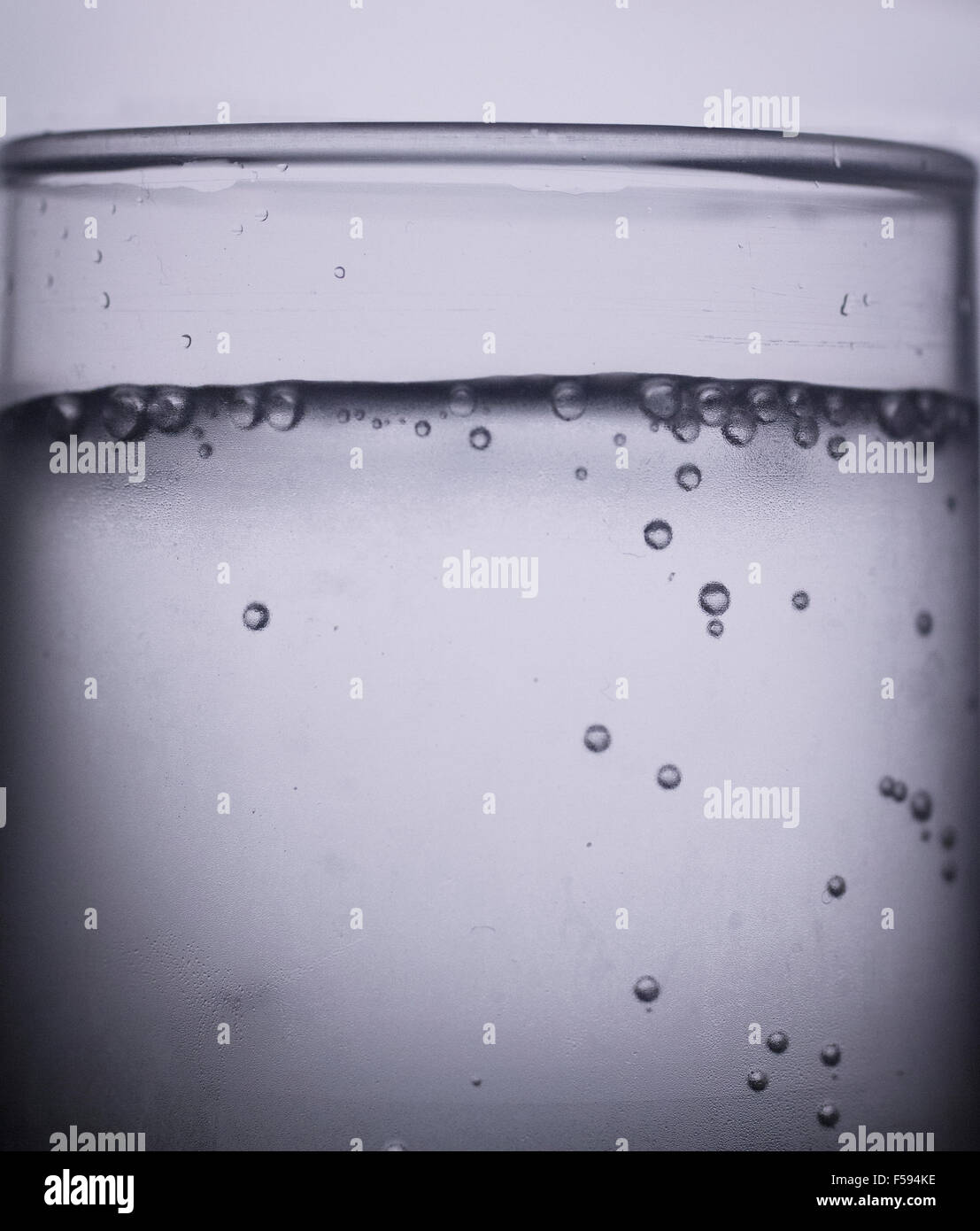 Glass of sparkling water soft drink closeup on carbon dioxide gas