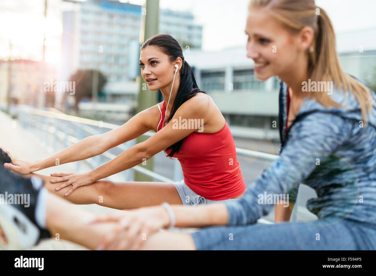 Warming up for jogging by stretching feet muscle Stock Photo