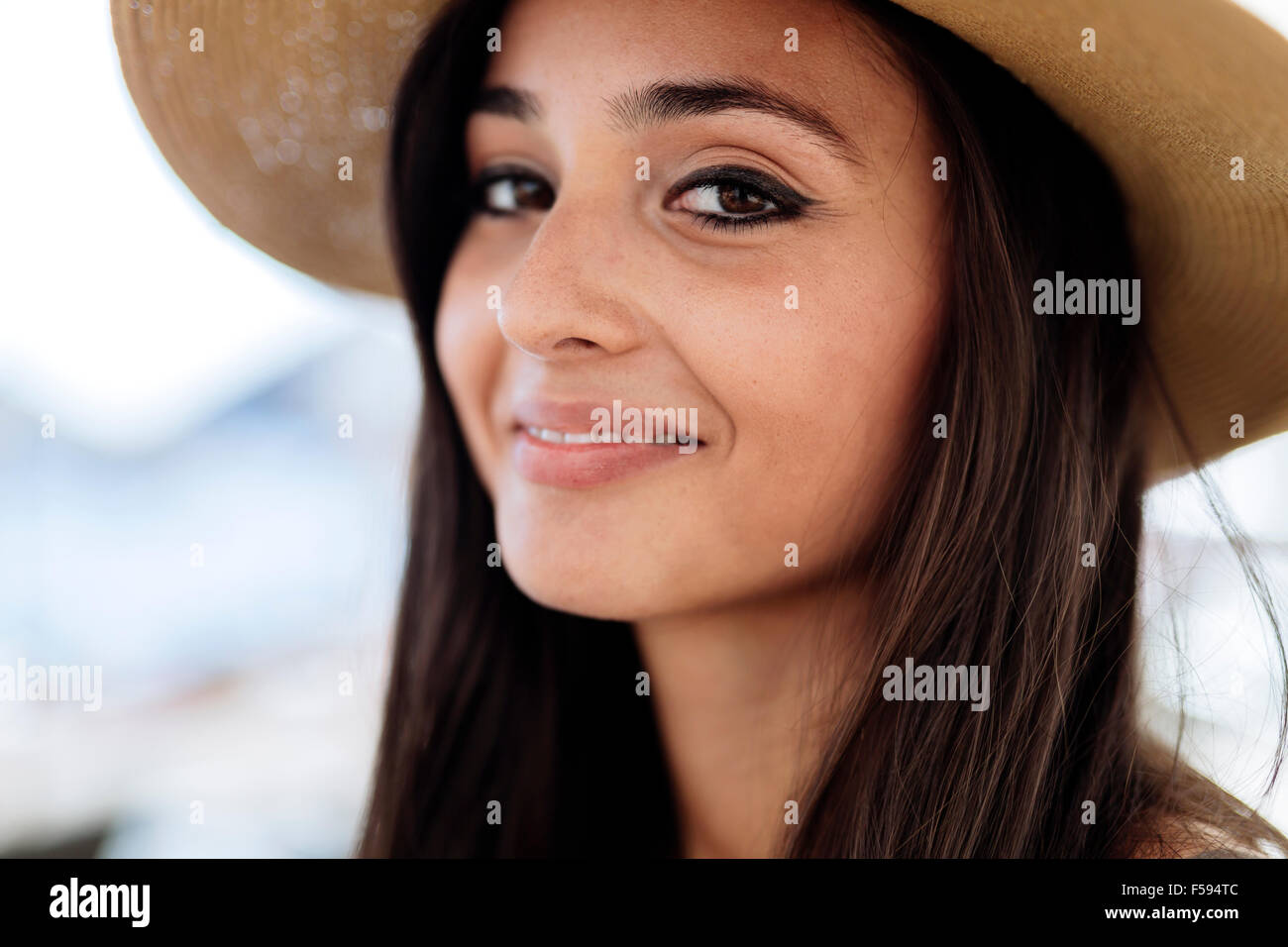 Attractive young woman in hat smiling Stock Photo