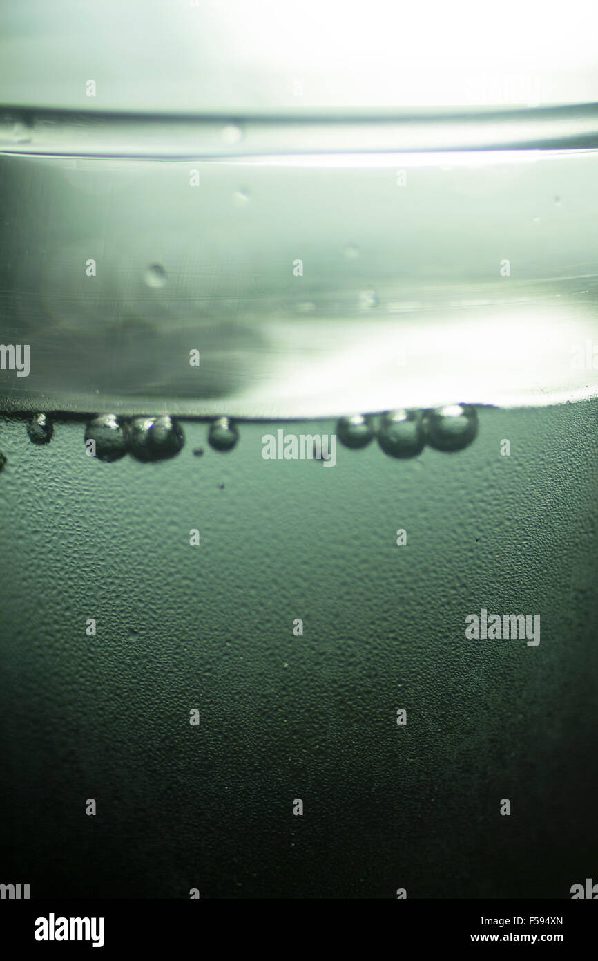 Glass of sparkling water soft drink closeup on carbon dioxide gas