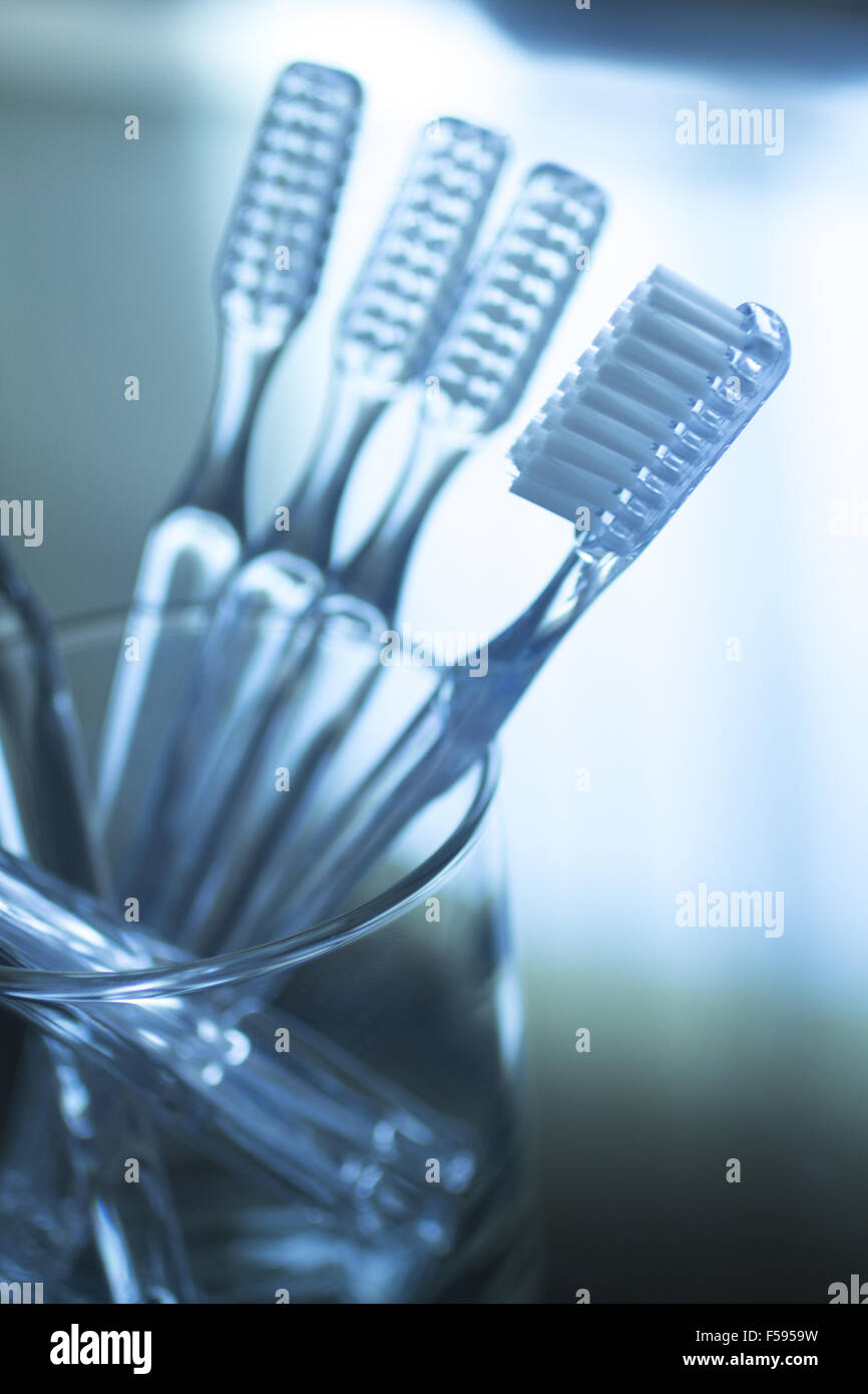 Toothbrushes in glass on glass table dental hygiene plaque control in