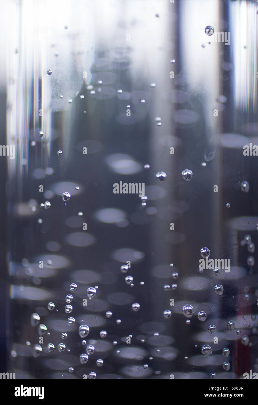 Glass of sparkling water soft drink closeup on carbon dioxide gas