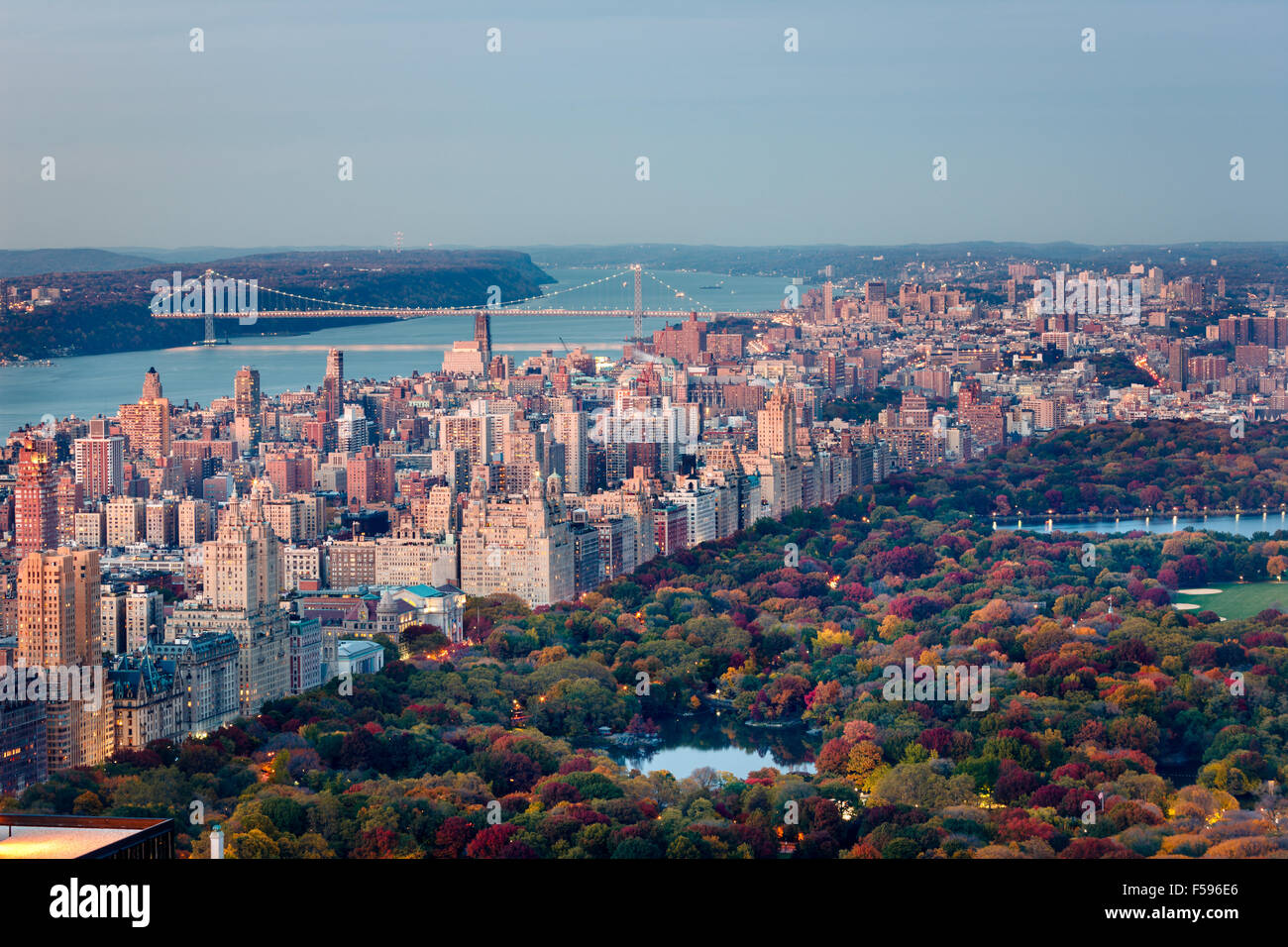 Aerial sunset view of Upper West Side of Manhattan and Central Park in Fall with George Washington Bridge and Hudson River. NYC Stock Photo