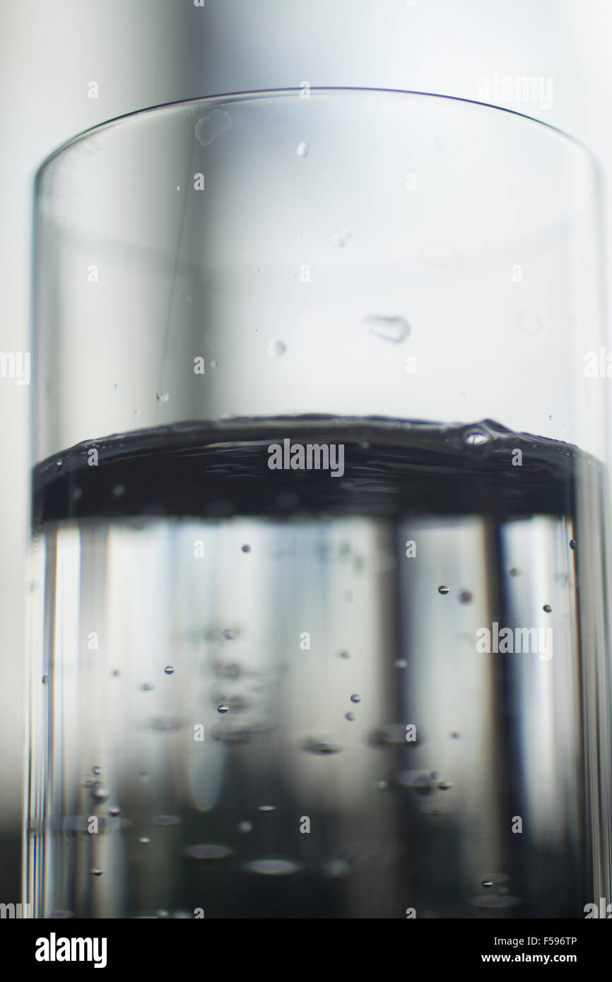 Glass of sparkling water soft drink closeup on carbon dioxide gas