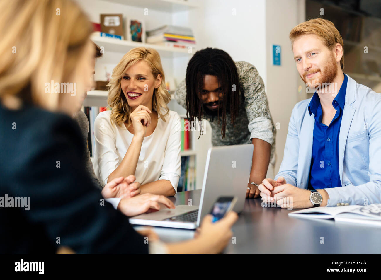 Team of skilled designers and business people working together on a project Stock Photo