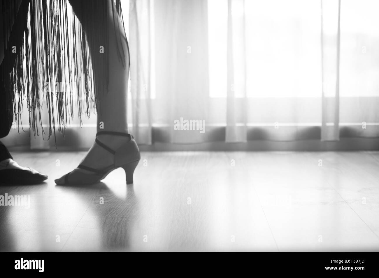 Dancing shoes feet and legs of female ballroom and latin salsa dancer