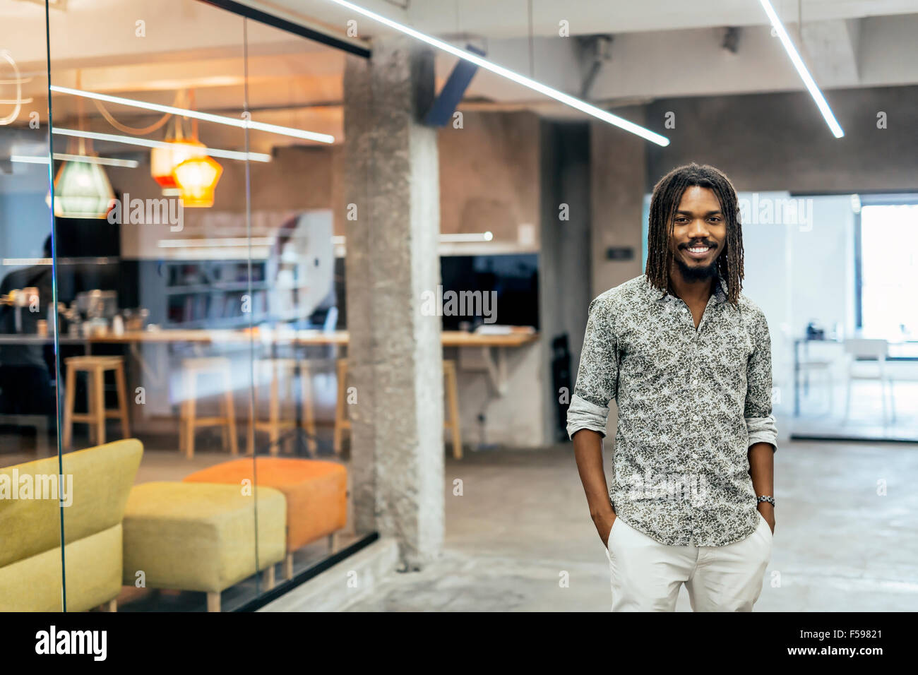 Handsome black designer standing in modern office Stock Photo