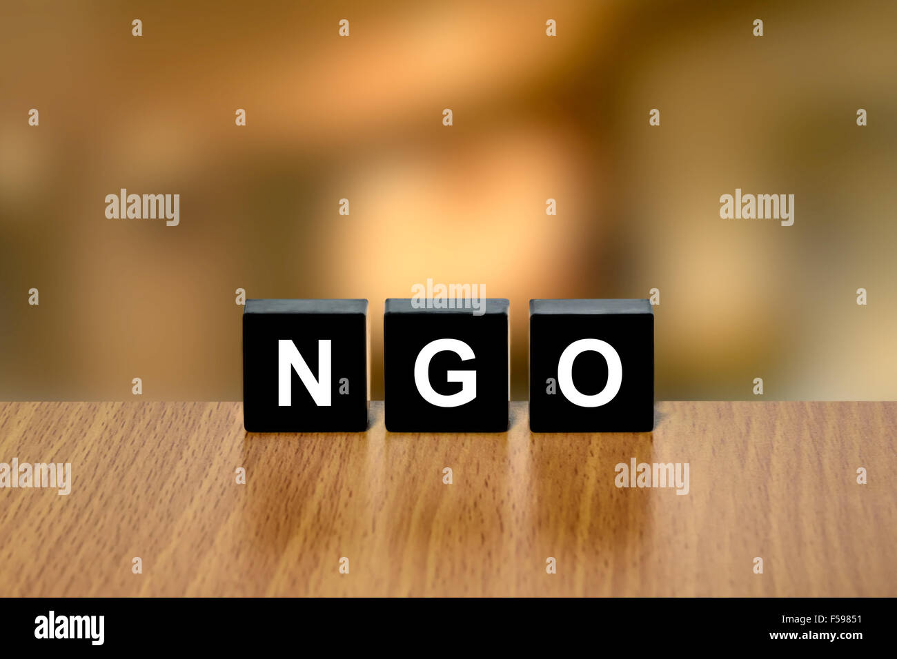 NGO or non-governmental organization on black block with blurred background Stock Photo