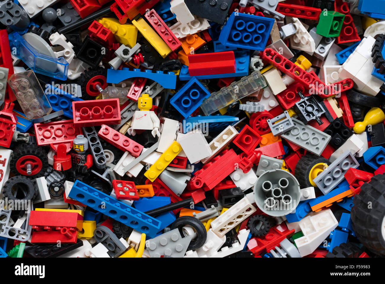 View from above into a box full of mixed colourful Lego bricks (multiple generations of Legos from 1970 till today) Stock Photo