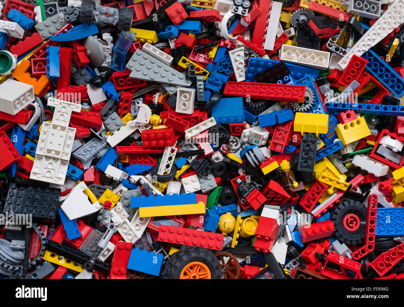 View from above into a box full of mixed colourful Lego bricks (multiple generations of Legos from 1970 till today) Stock Photo