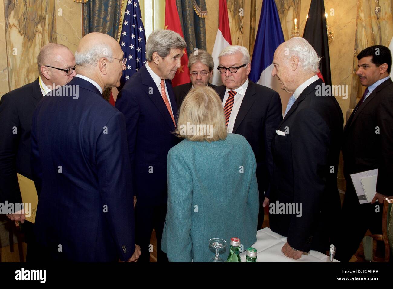 US Secretary of State John Kerry chats with German Foreign Minister Frank-Walter Steinmeier, United Nations Special Envoy for Syria Staffan de Mistura, and Assistant Secretary of State for Near Eastern Affairs Anne Patterson at the Imperial Hotel October 30, 2015 in Vienna, Austria. The gathering is to discussion ways to end the fighting in Syria. Stock Photo