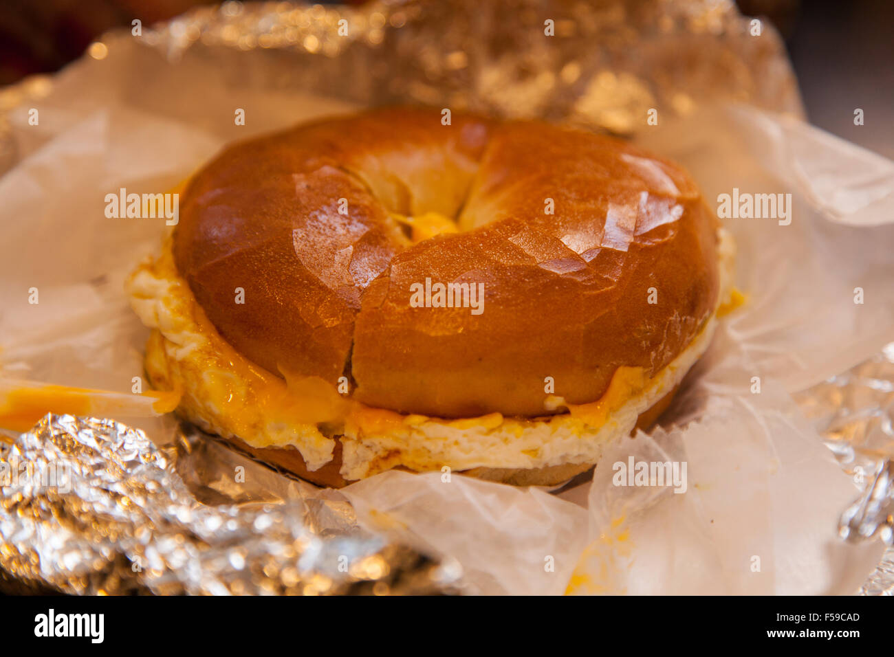 Egg and cheese toasted bagel Dali market delicatessen, 7th Avenue, New York City, United States of America. Stock Photo