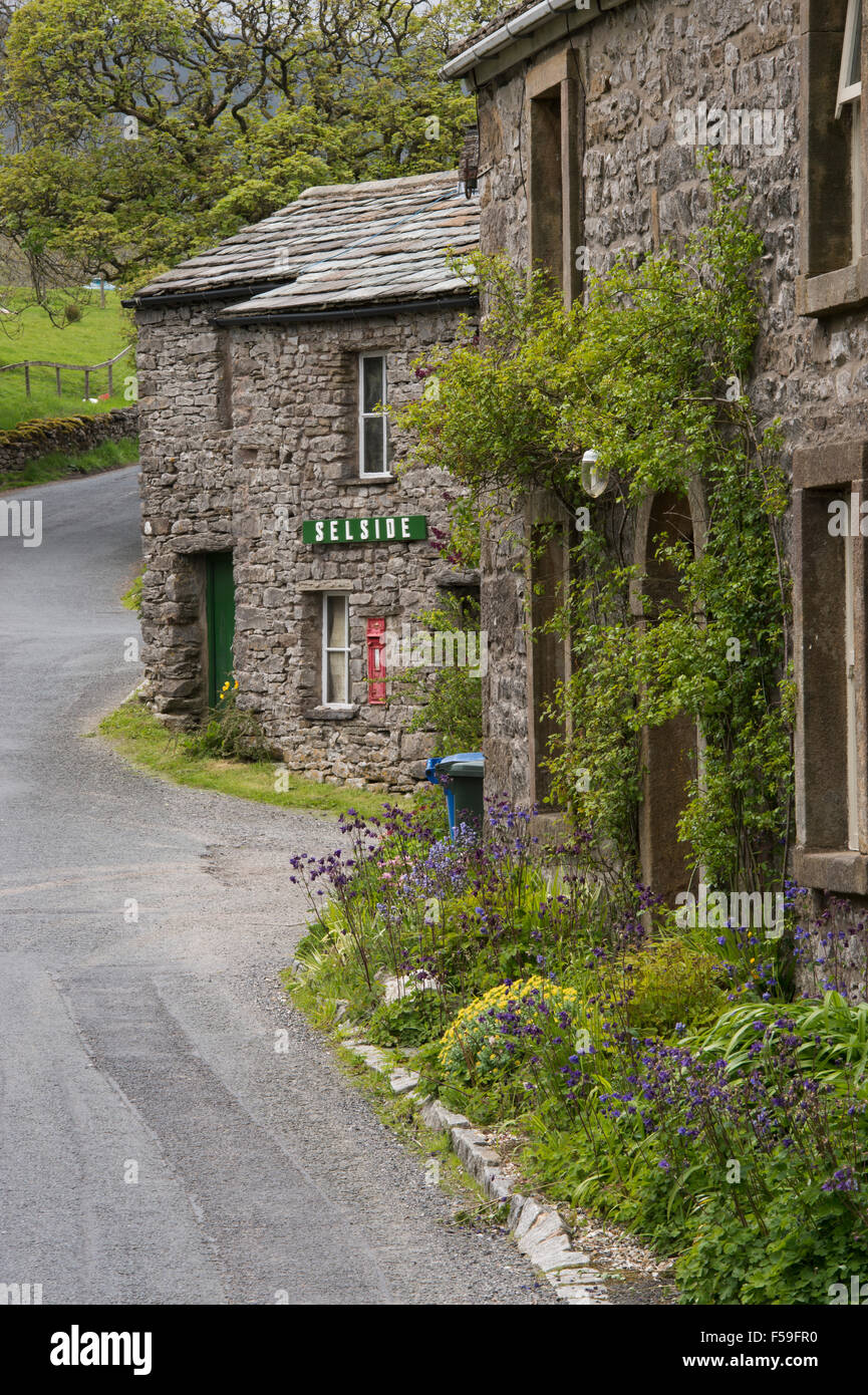 Traditional, stone-built, roadside cottages (with name sign & post box) in the quaint hamlet of Selside, Yorkshire Dales National Park, England UK. Stock Photo