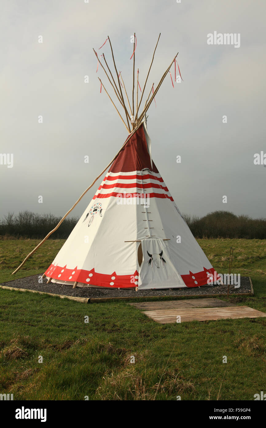 A new Indian style tent, wigwam or Tepee out on a plot of land in a field and hired out to campers Stock Photo