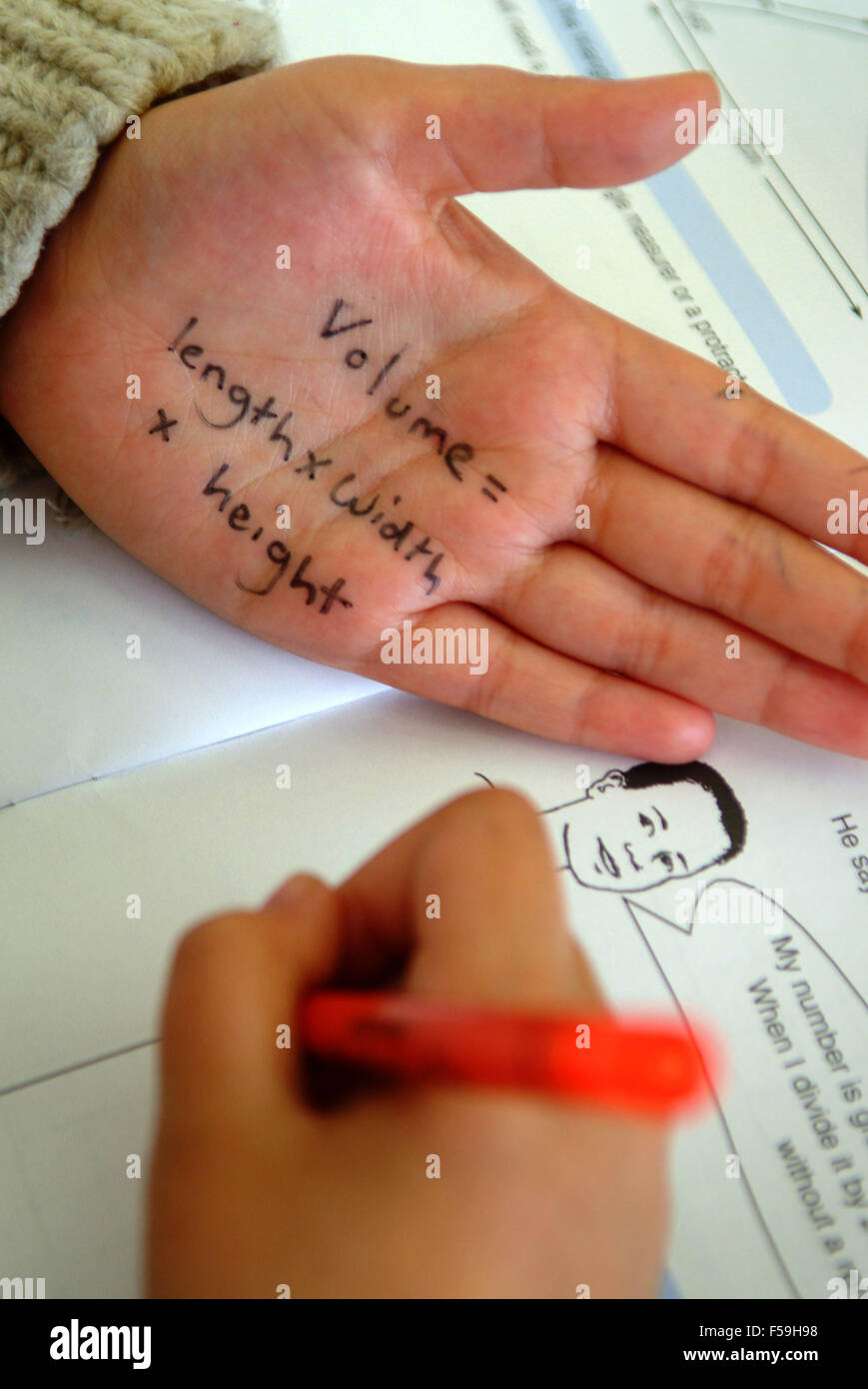 Students sitting their year 6 SATs test at Roath Park Primary School,Cardiff, Wales,UK,with one boy cheating.a UK education exam Stock Photo