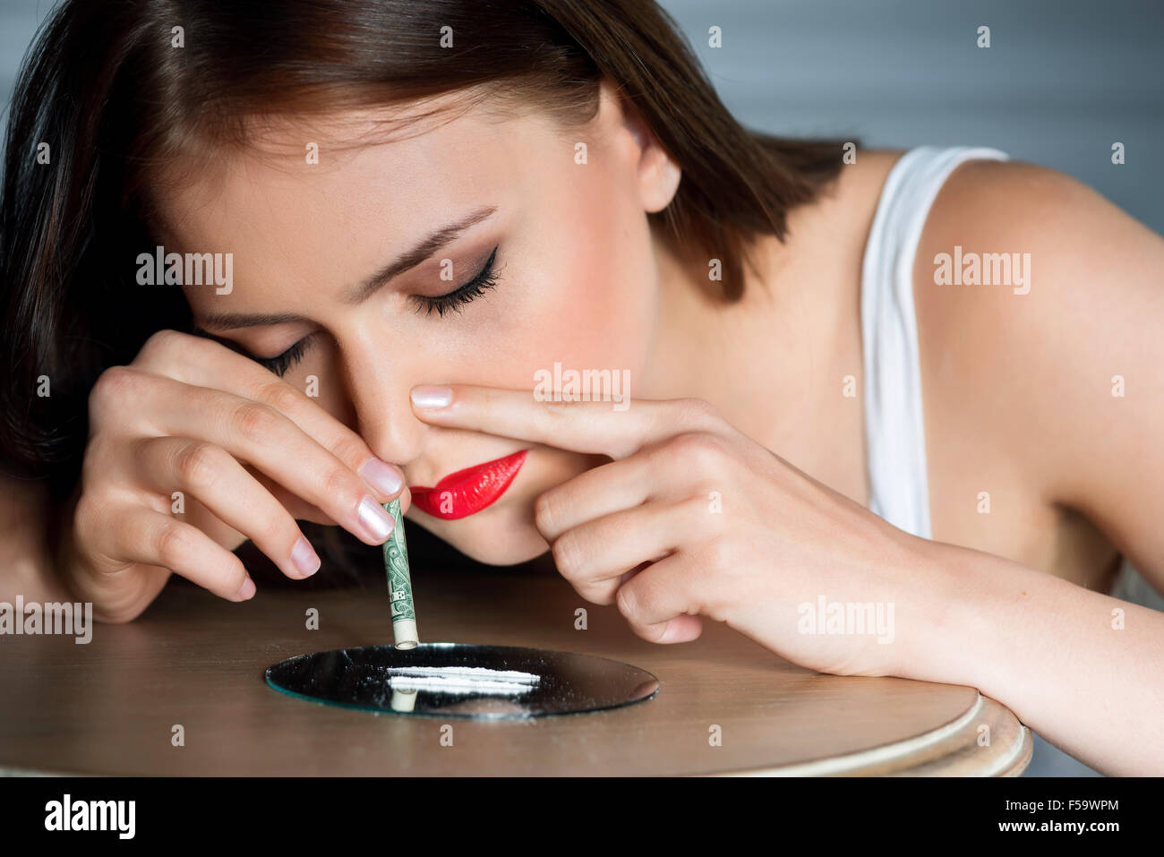 Young girl taking drugs Stock Photo