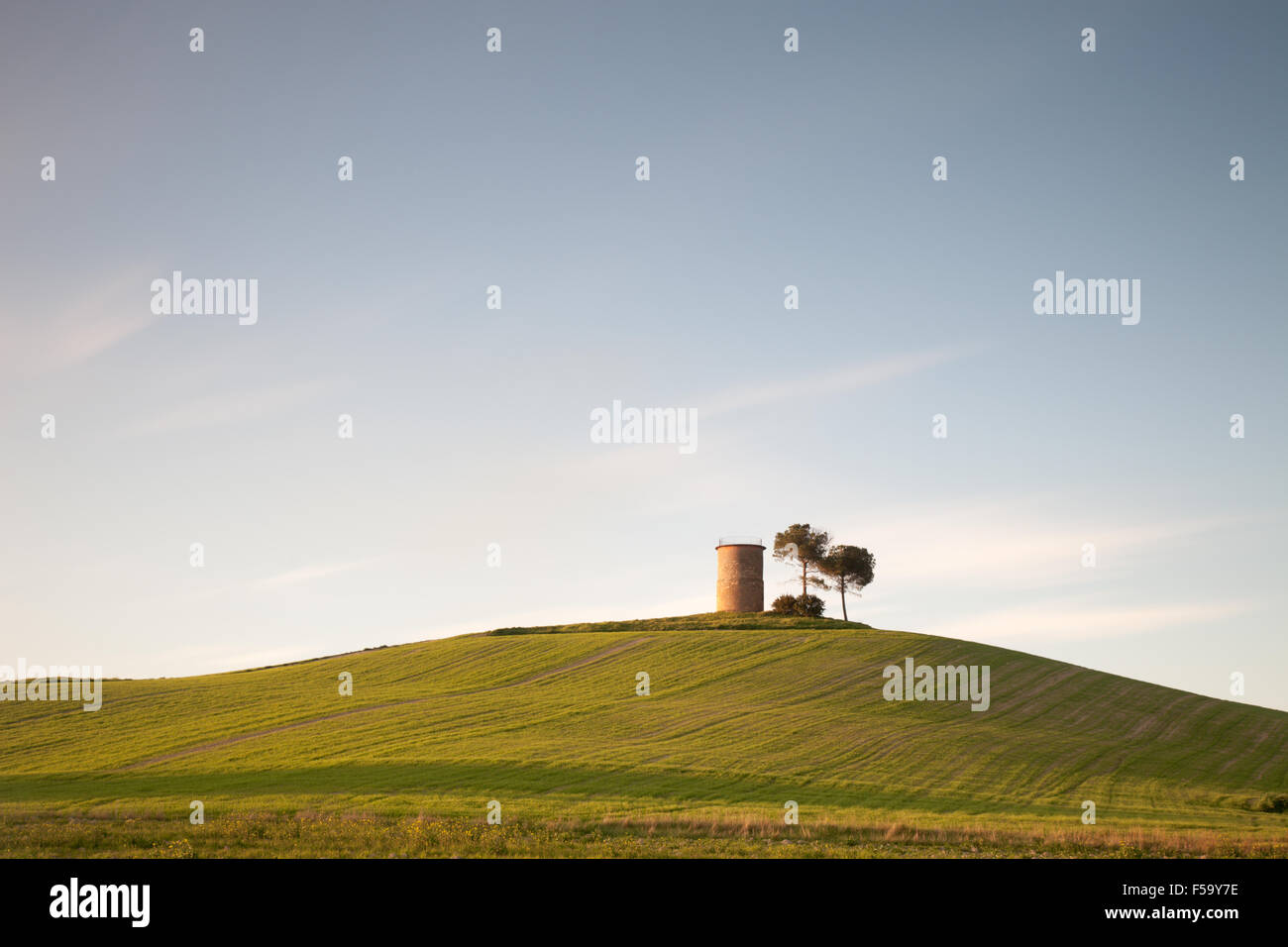 Tuscany: typical countryside landscape with rolling hills, trees and rural tower. Stock Photo