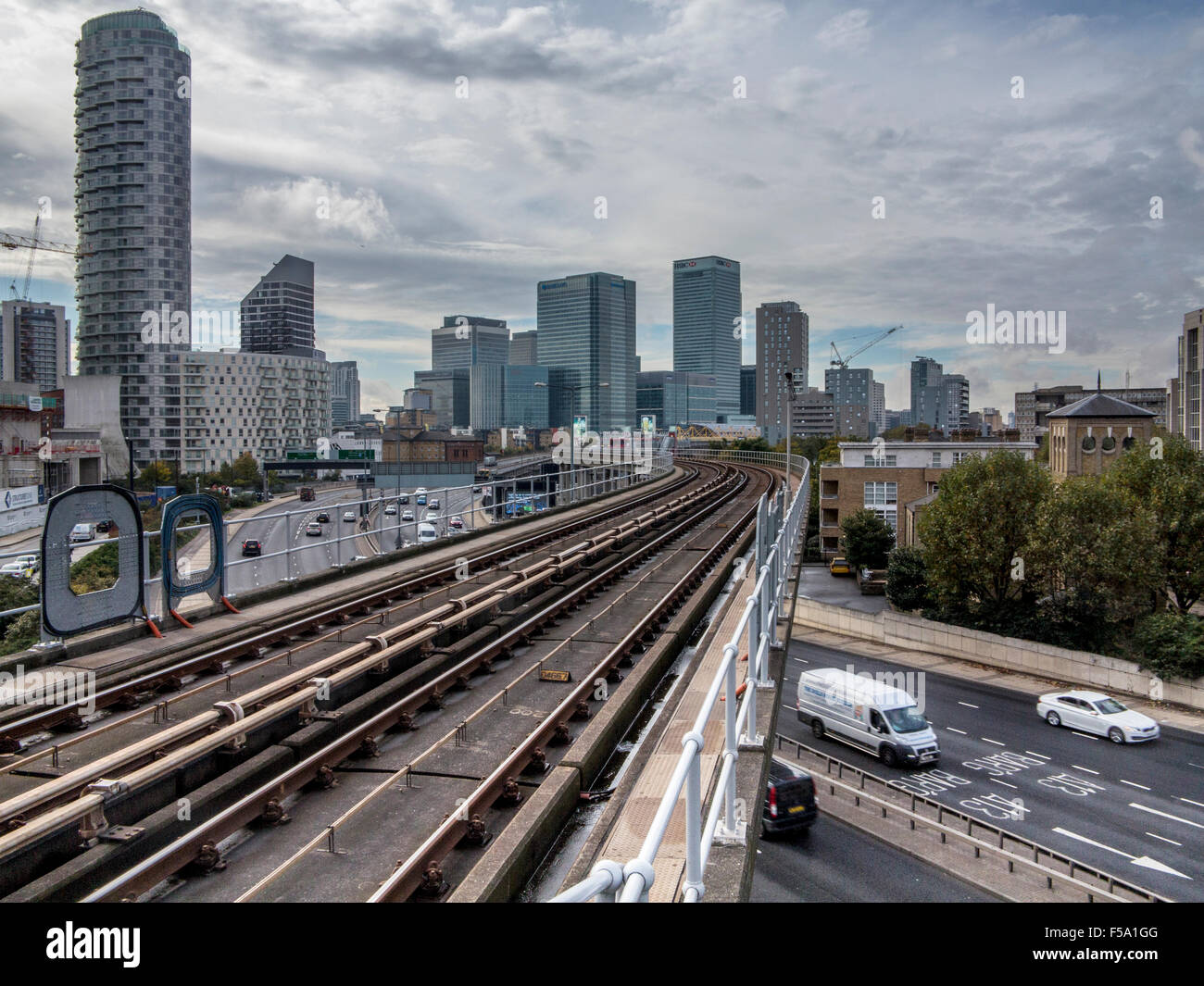 Docklands Light Railway track with Canary Wharf and the docklands in the background Stock Photo