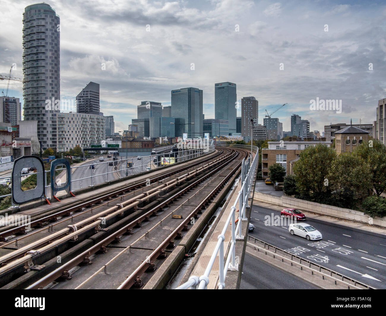 Docklands Light Railway track with Canary Wharf and the docklands in the background Stock Photo