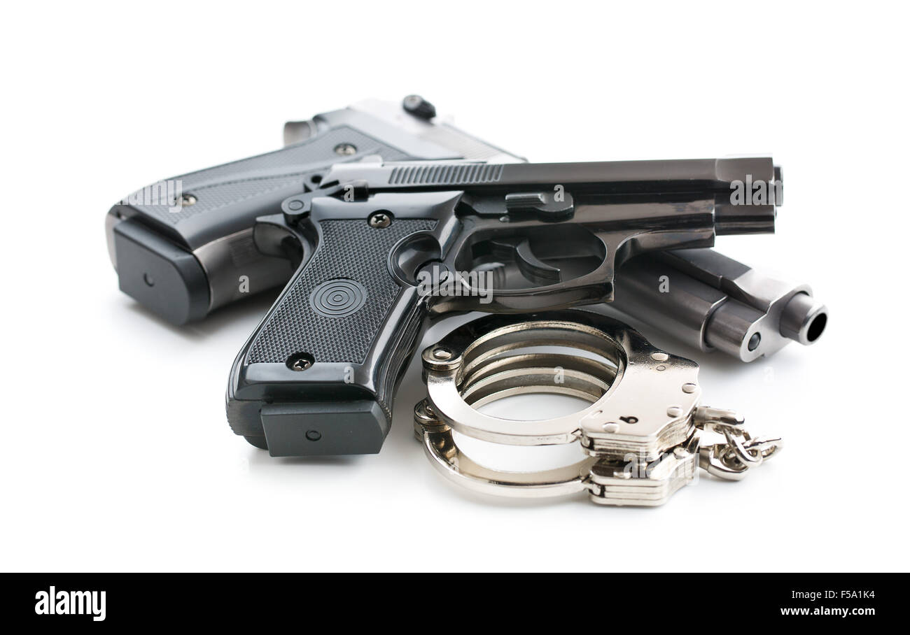 handguns and handcuffs on white background Stock Photo