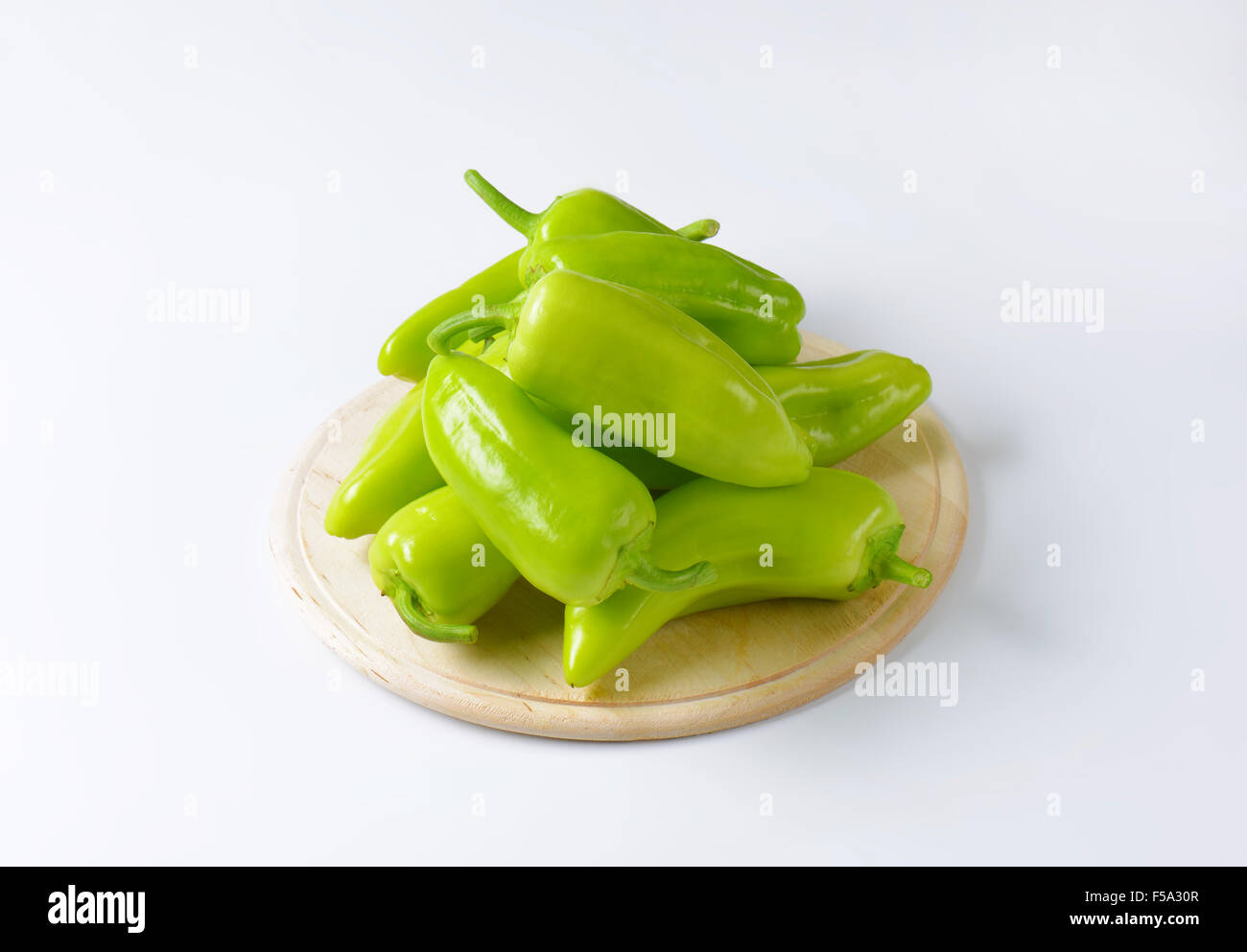 Group of raw green peppers on white background Stock Photo - Alamy