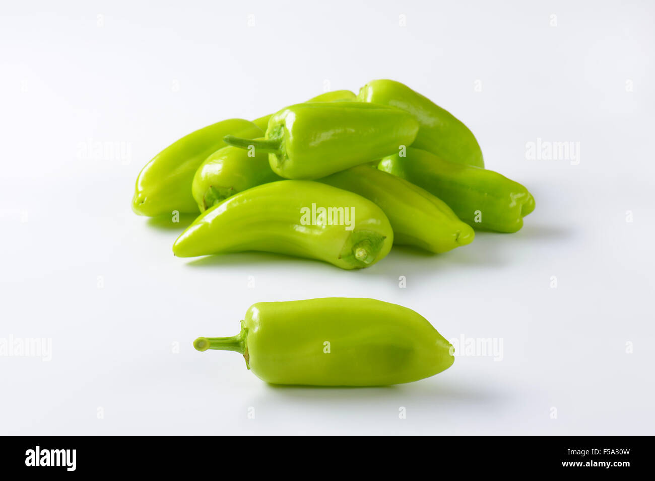 Group of raw green peppers on white background Stock Photo - Alamy