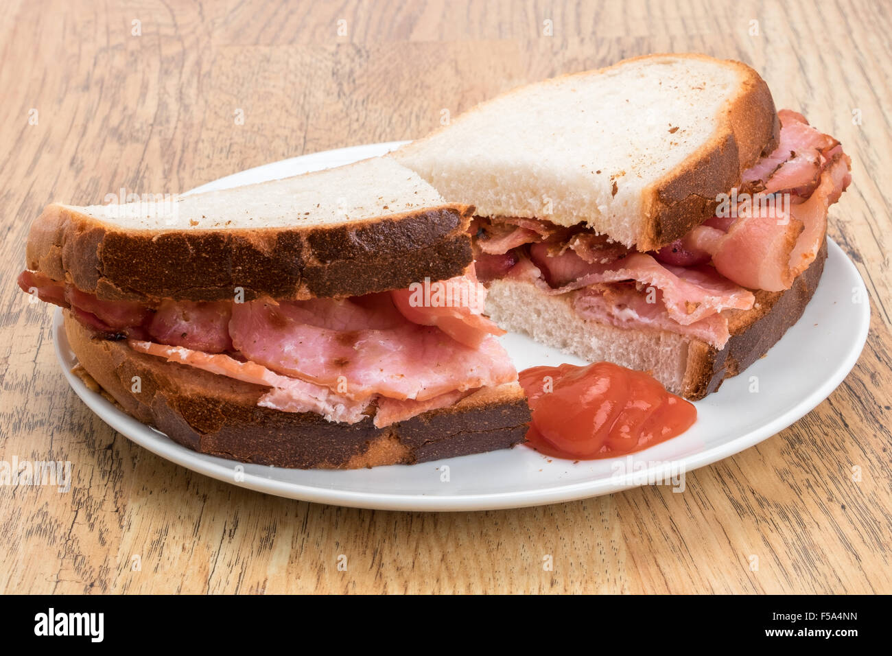 Crispy bacon inside a crusty bread sandwich Stock Photo