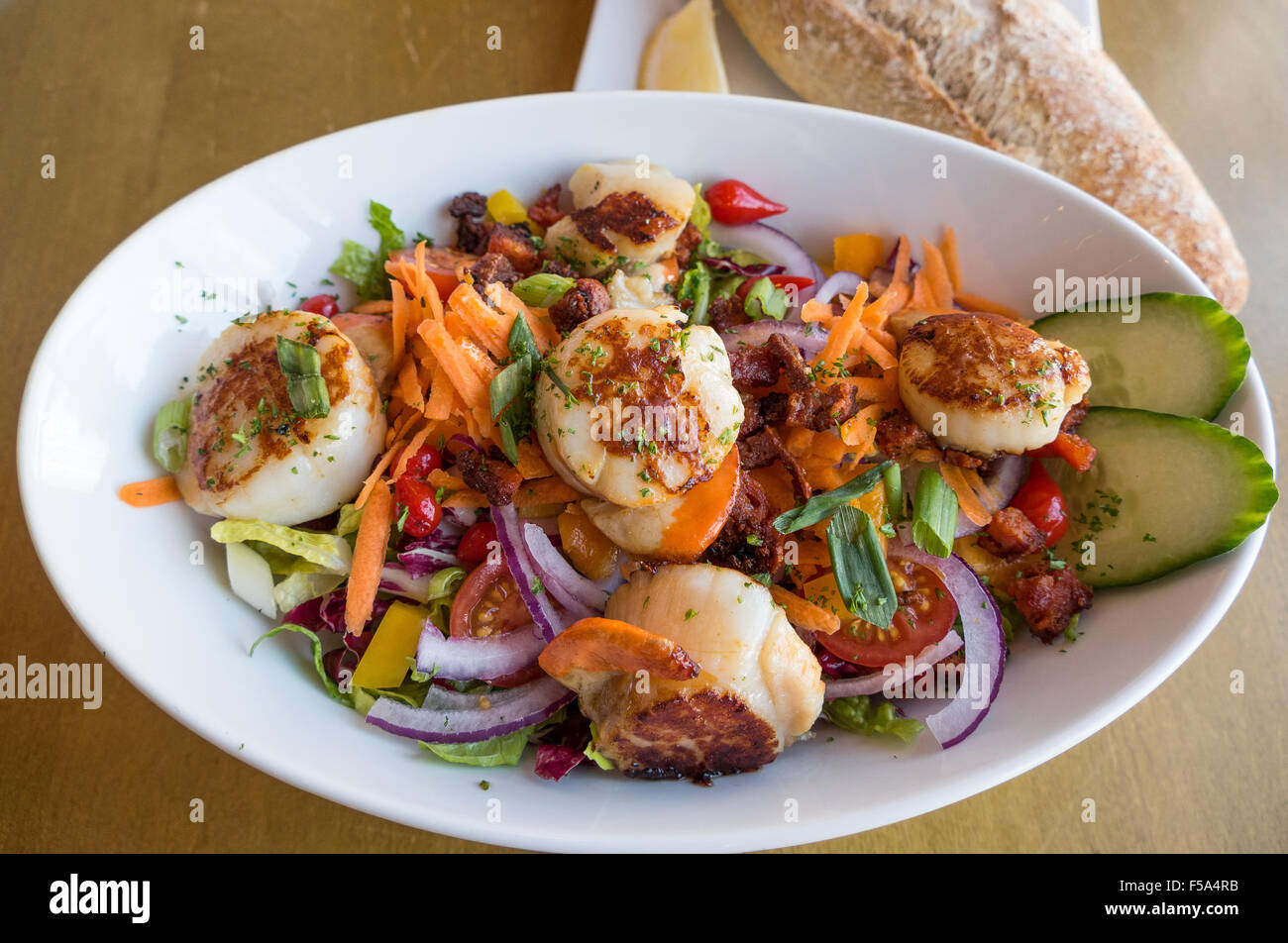 Pan fried scallops with chorizo sausage and salad Stock Photo