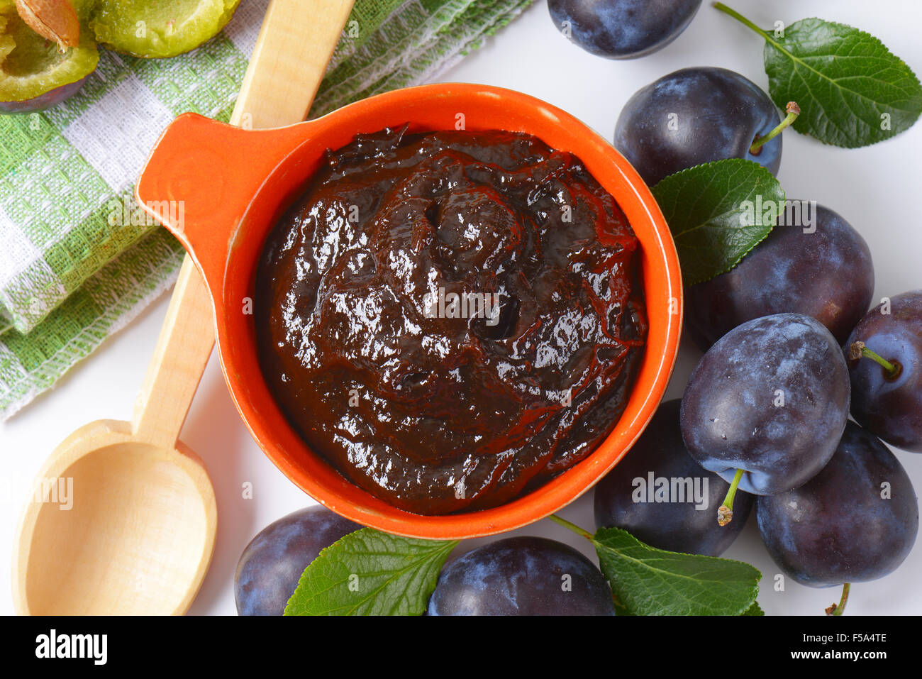 Bowl of plum preserve and fresh plums Stock Photo
