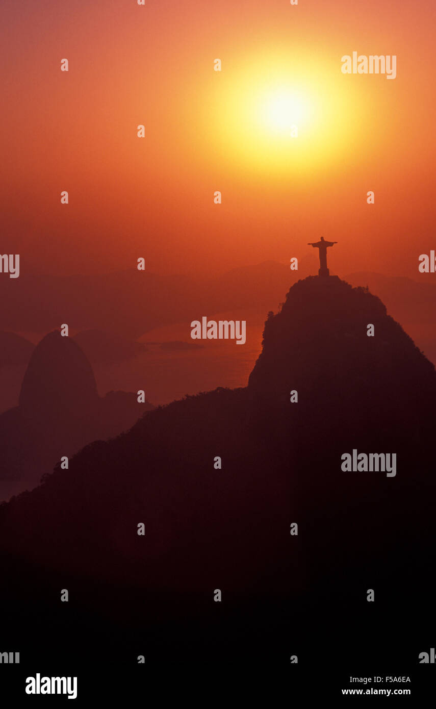 Sunrise at Christ the Redeemer statue, Sugar Loaf Mountain in background, Rio de Janeiro landmarks, Brazil. Stock Photo