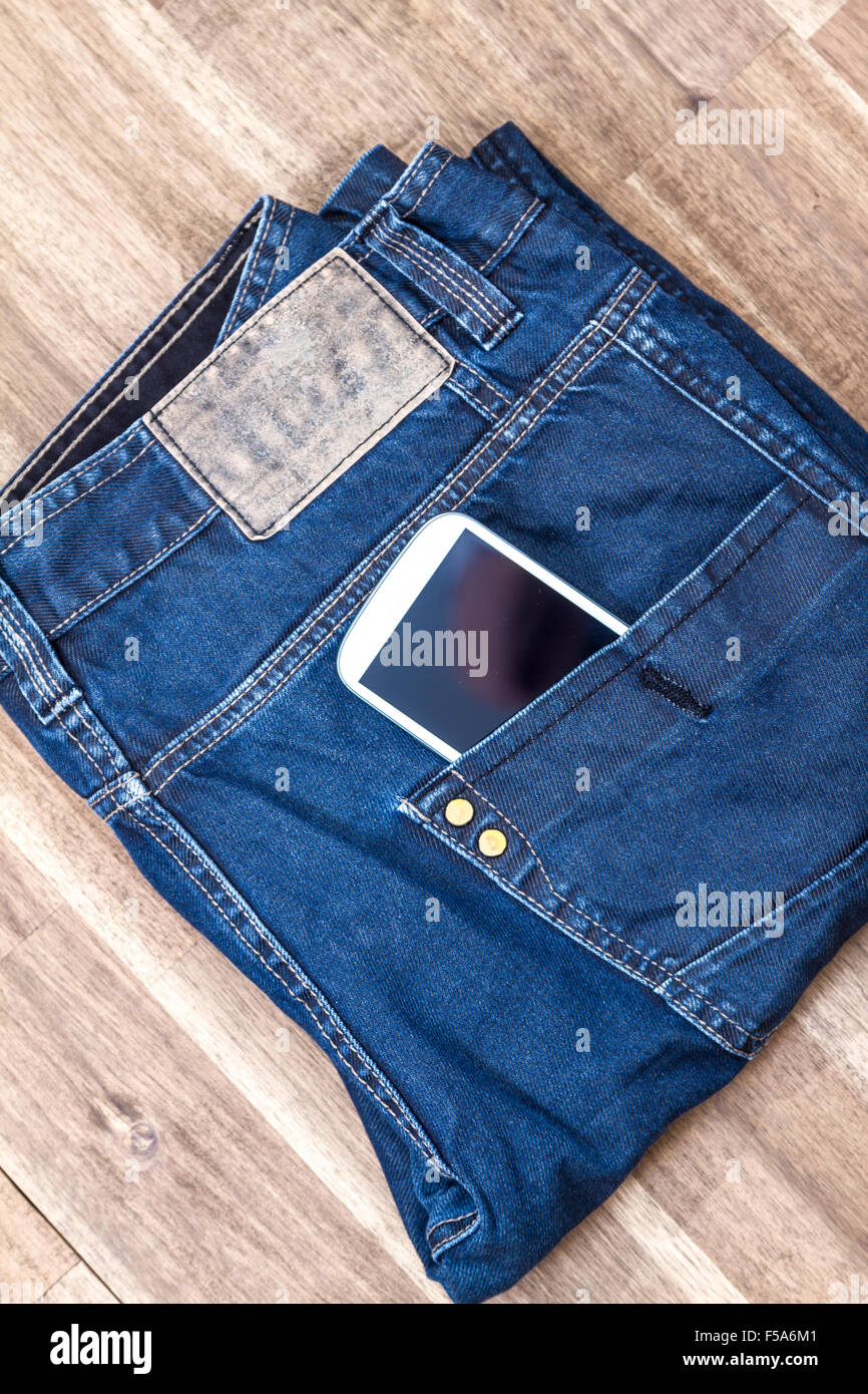 Jeans with cellphone in the pocket, background Stock Photo