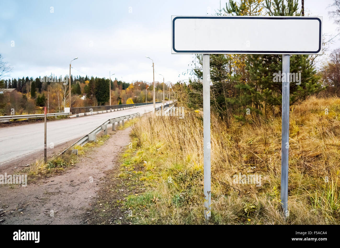 Empty roadsign stands near rural European highway Stock Photo
