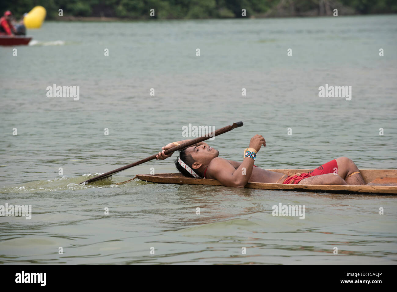 Palmas, Brazil. 30th October, 2015. A Matis competitor lies back in relief after his heat in the canoeing event at the International Indigenous Games, in the city of Palmas, Tocantins State, Brazil. Credit:  Sue Cunningham Photographic/Alamy Live News Stock Photo