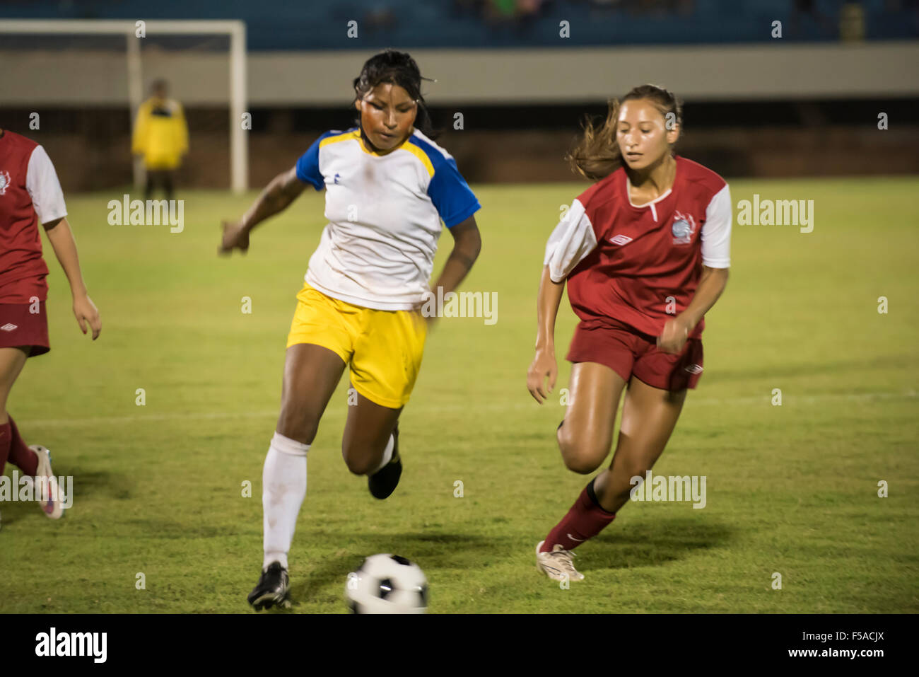 Palmas, Brazil. 30th October, 2015. Two women compete for the ball during the final of the women's football, between the local Xerente tribe and the Native American team from the USA at the International Indigenous Games in the city of Palmas, Tocantins State, Brazil. The USA won on a penalty shoot-out after a 0-0 match. Credit:  Sue Cunningham Photographic/Alamy Live News Stock Photo