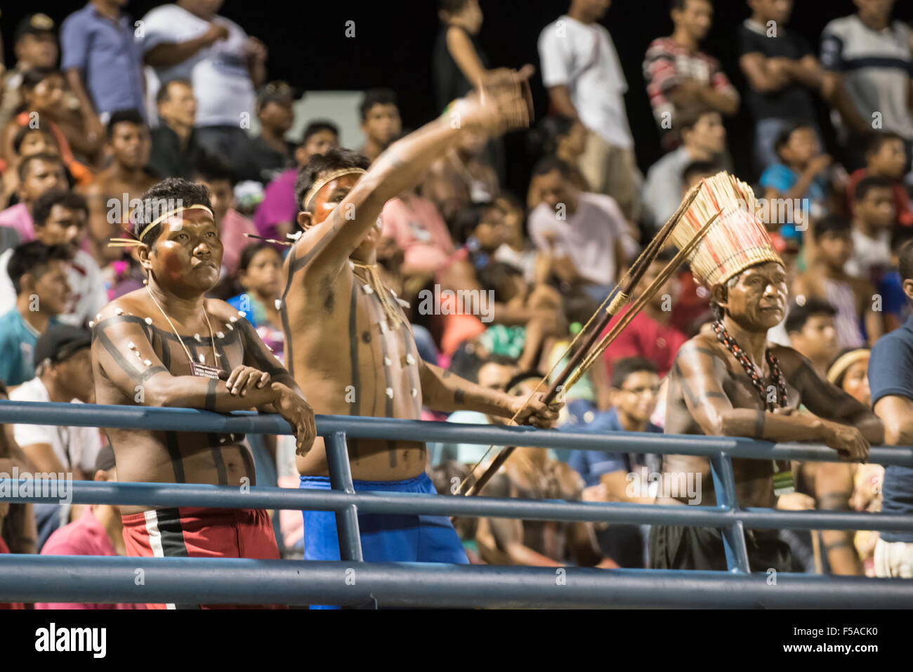 Palmas, Brazil. 30th October, 2015. Xerente warriors cheer in support of their women's team during the final of the women's football, between the local Xerente tribe and the Native American team from the USA at the International Indigenous Games in the city of Palmas, Tocantins State, Brazil. The USA won on a penalty shoot-out after a 0-0 match. Credit:  Sue Cunningham Photographic/Alamy Live News Stock Photo